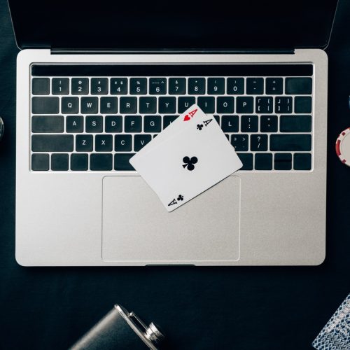 Online gambling concept with chips and money on laptop